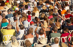 Country music fans in the VIP section enjoying the show